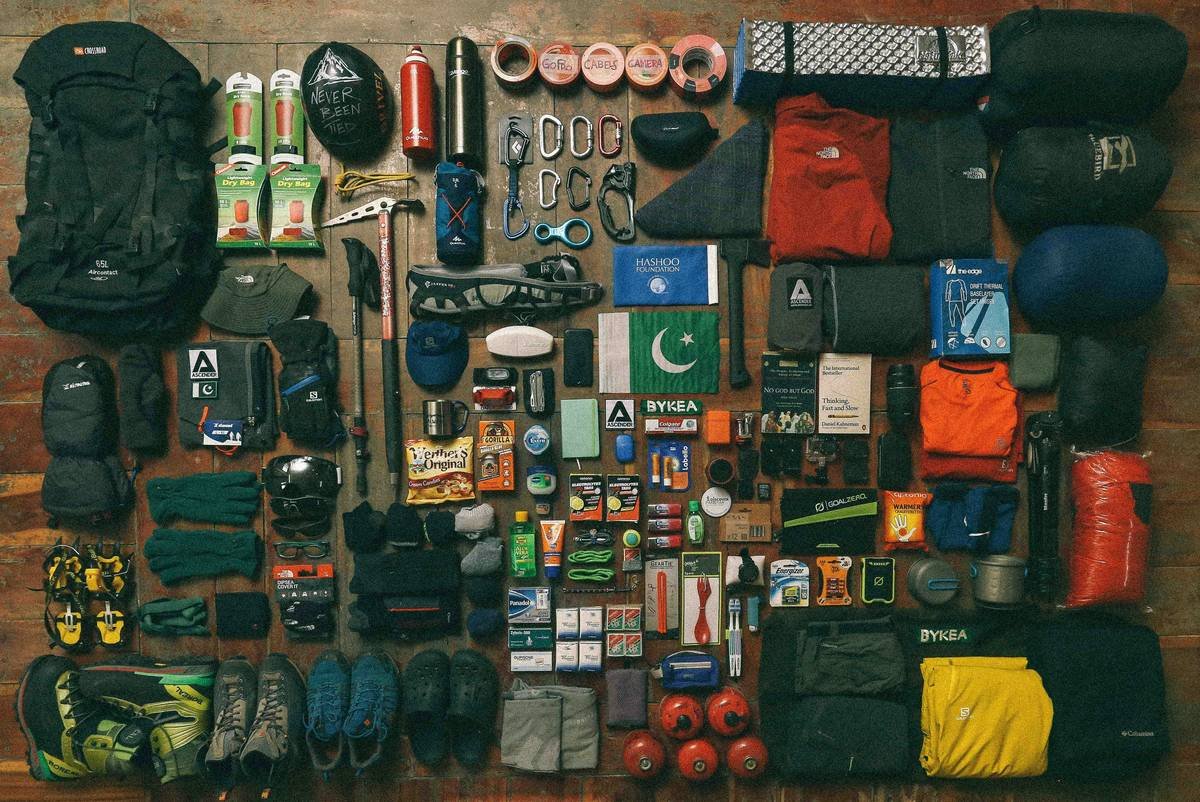 Comparison chart of essential camping and climbing gear for beginners including tents, stoves, headlamps, and tricams vs cams vs nuts